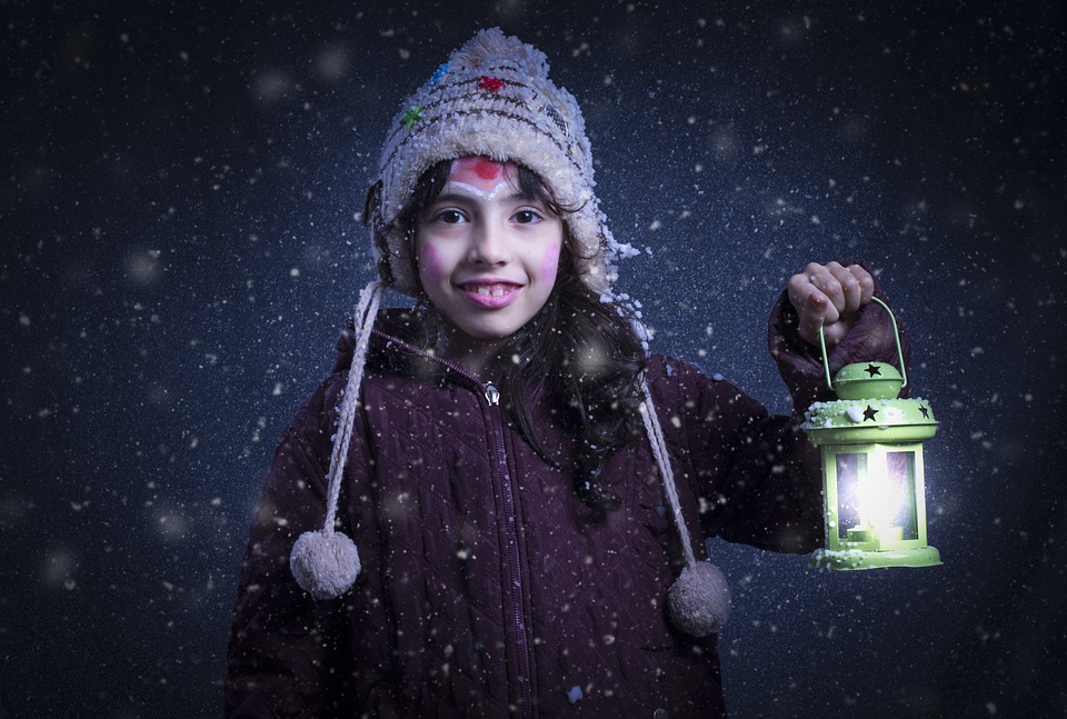 A kid holding a lamp